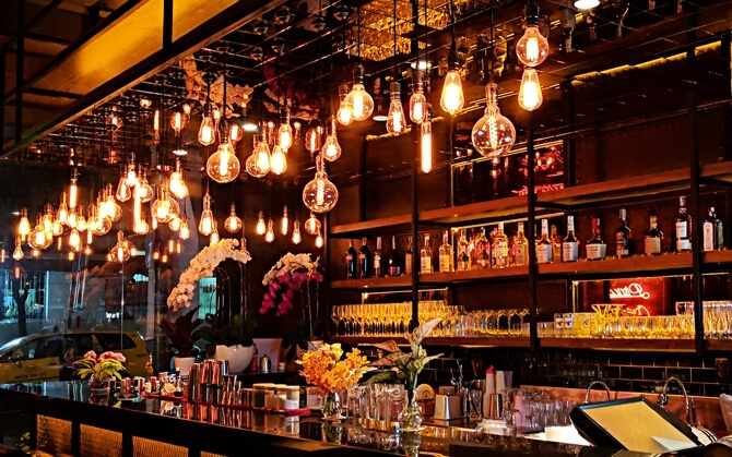 a brightly lit bar with a large selection of alcohol